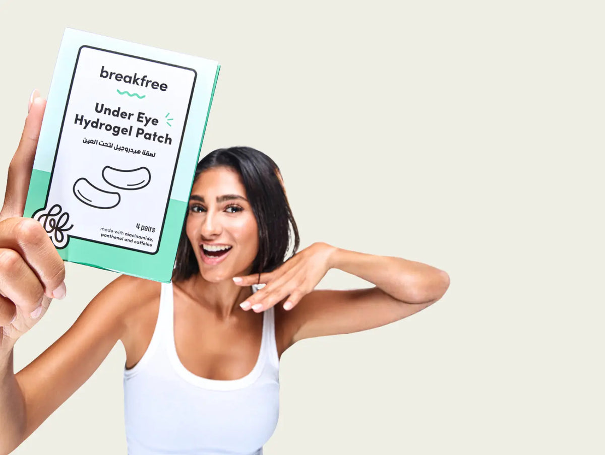 Woman holding a pack of Breakfree Undereye Hydrogel Patch